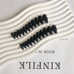KQueenest size comparison on a finger showing medium almond length for natural fit
