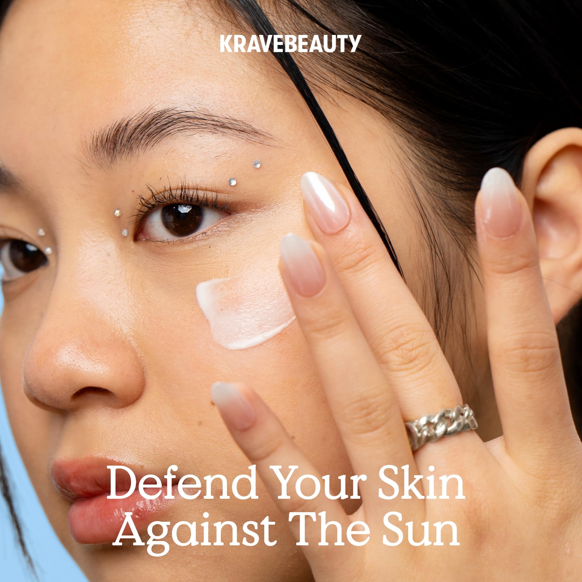 kravebeauty applying sunscreen on hand for quick absorption benefit