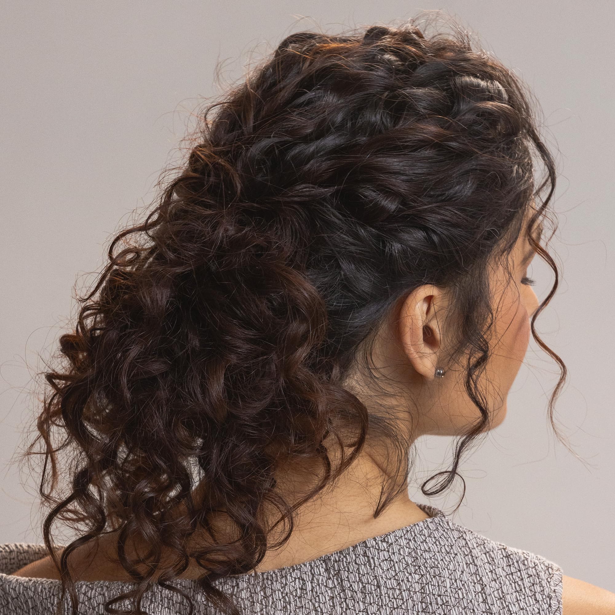 Kristin Ess being applied to damp curls to show frizz control benefit