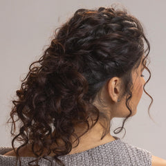 Kristin Ess being applied to damp curls to show frizz control benefit