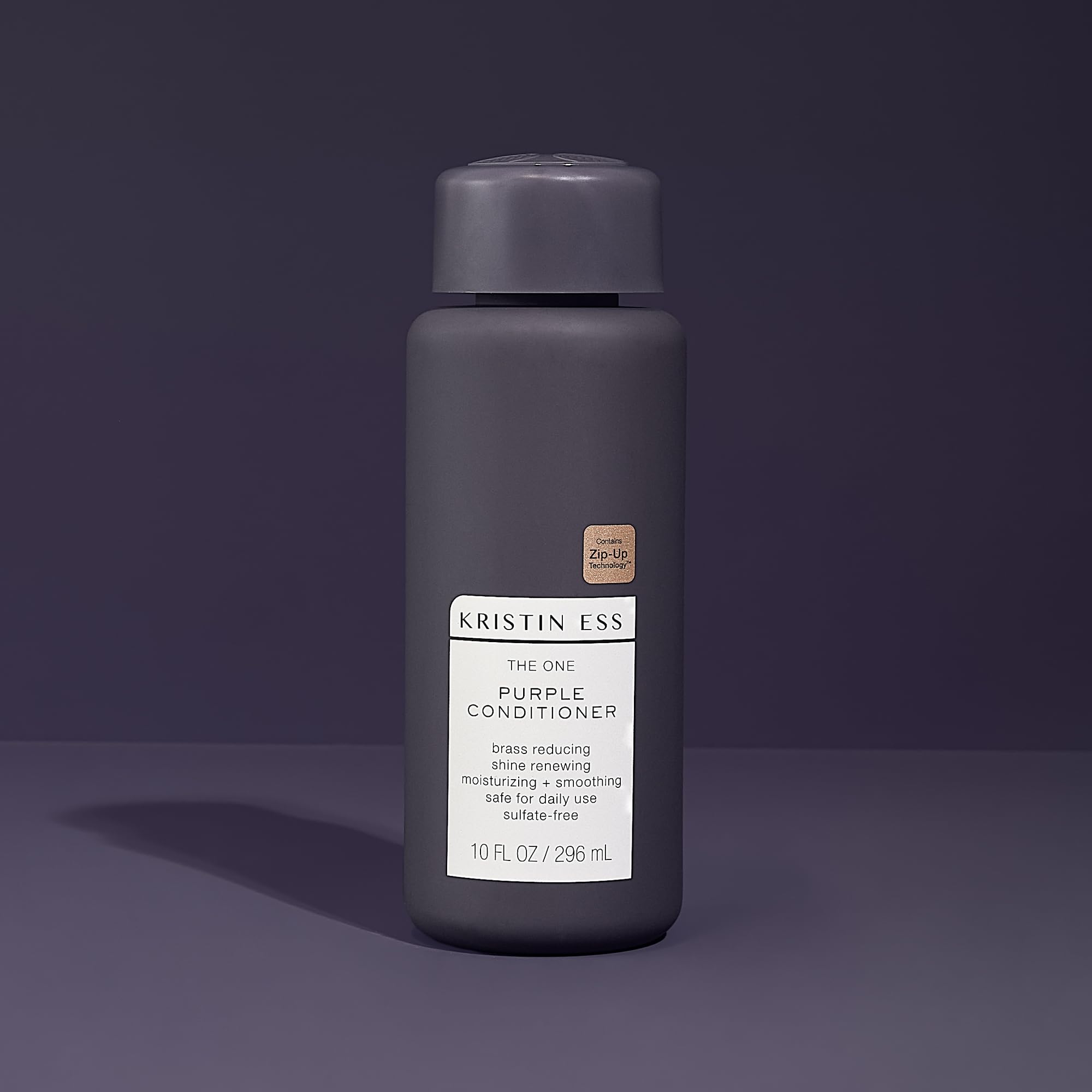 Kristin Ess purple conditioner swatch on hand illustrating pigment strength