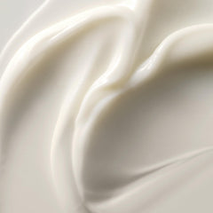 Kristin Ess applied to damp curly hair showing defined, frizz-controlled waves