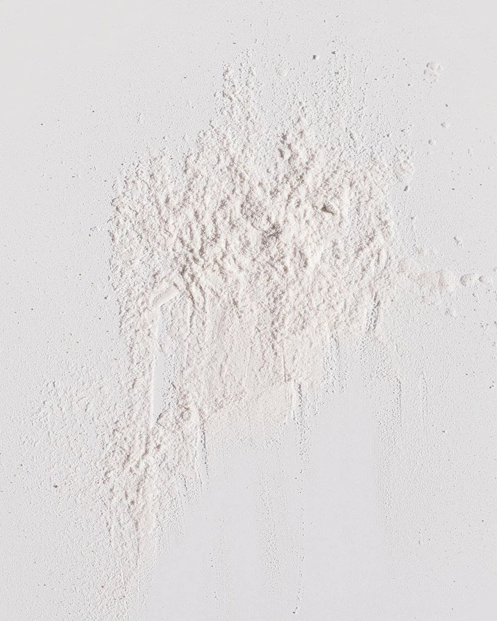 Kristin Ess open jar close-up of powder texture for easy blending
