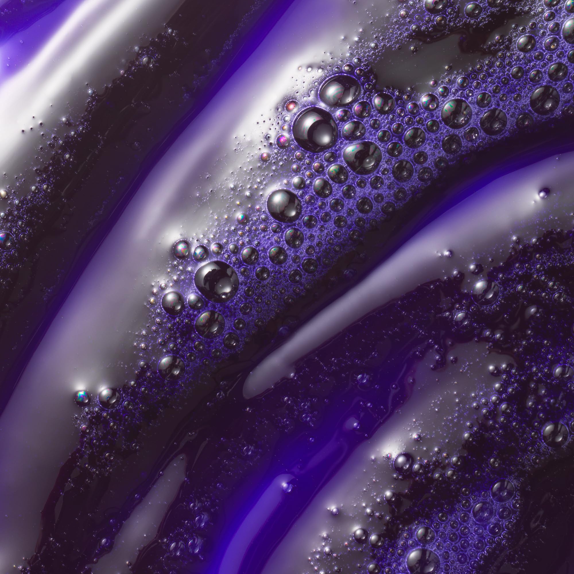 Kristin Ess purple shampoo lather texture demonstrating toning pigment and conditioning