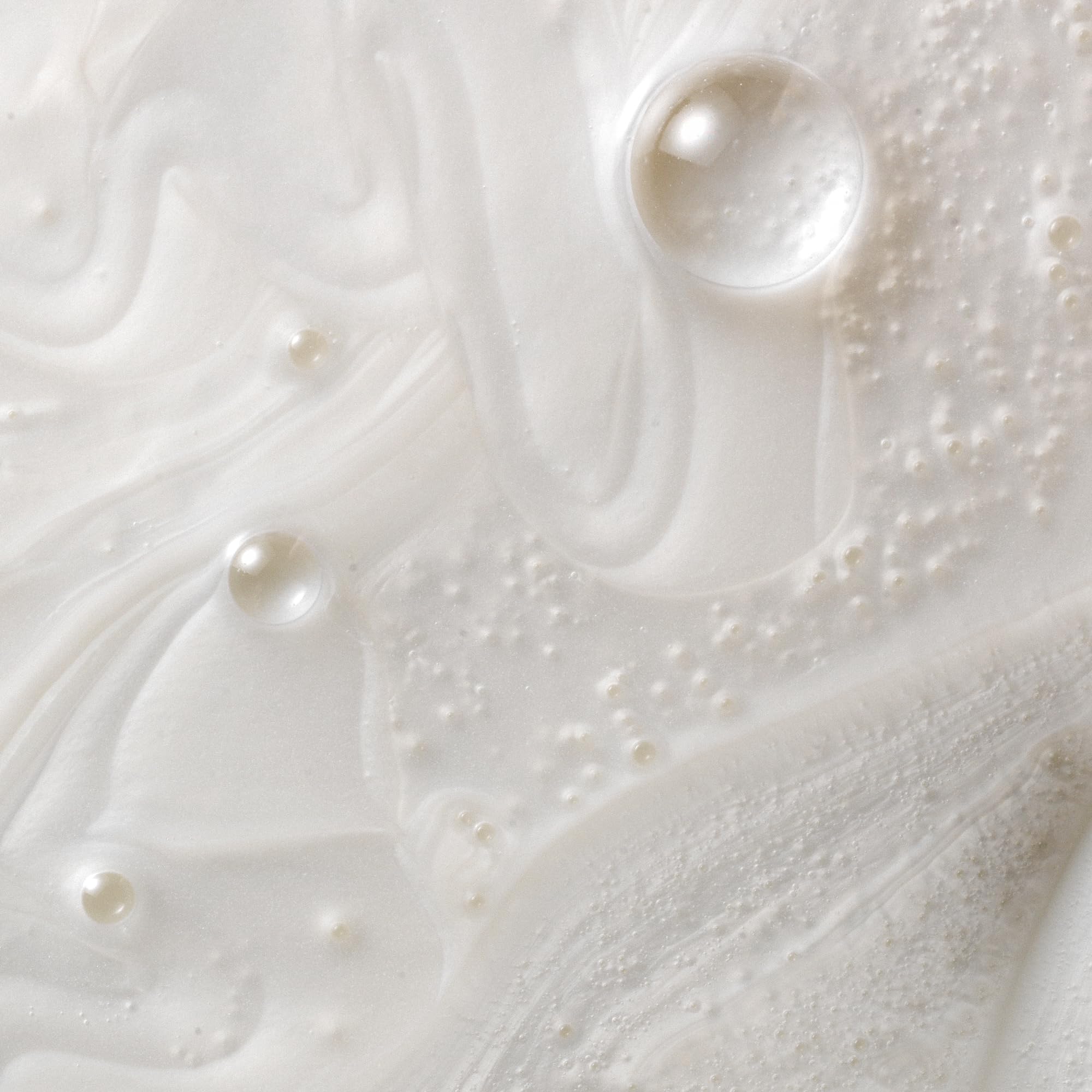 Creamy shampoo texture swatch showing Kristin Ess moisturizing feel