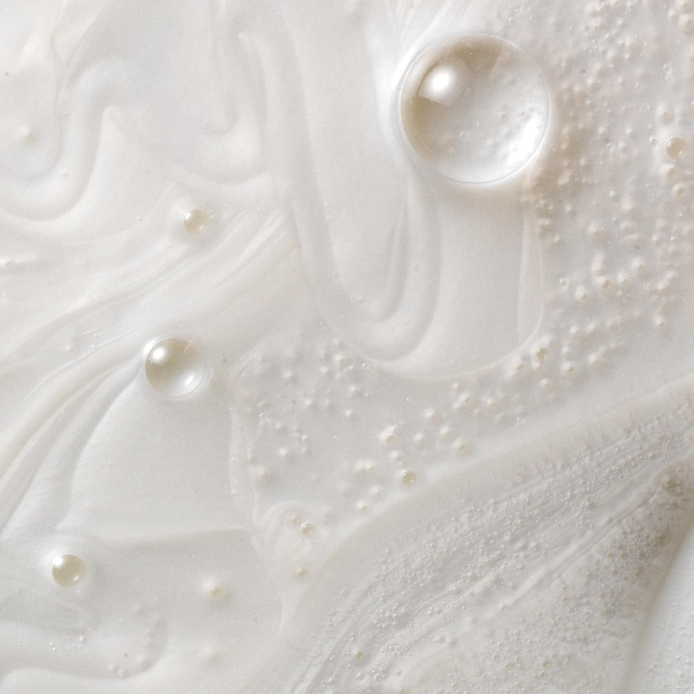 Creamy shampoo texture swatch showing Kristin Ess moisturizing feel
