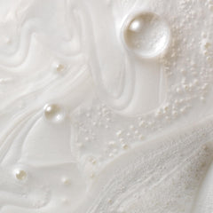 Creamy shampoo texture swatch showing Kristin Ess moisturizing feel