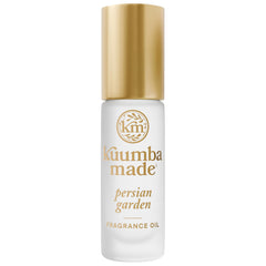 Kuumba Made front bottle view showing compact roll-on and elegant label benefit portability