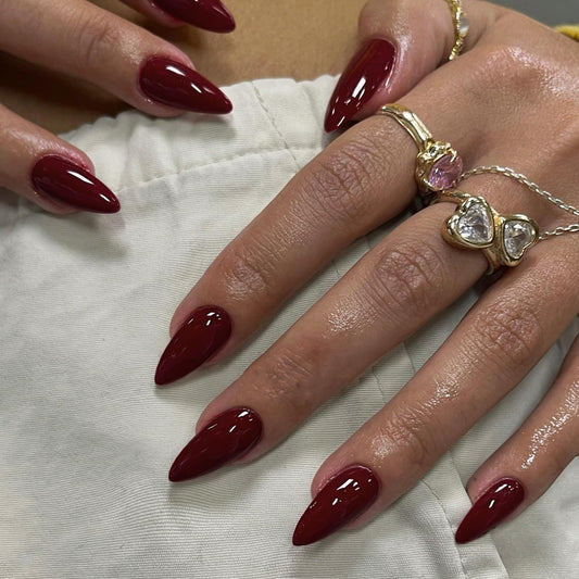 KXAMELIE front display of deep burgundy almond nails showing full set and shade benefit
