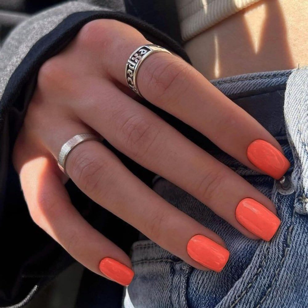 KXAMELIE close-up of glossy coral orange texture highlighting long-lasting gel-like shine
