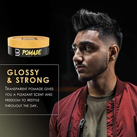 Hand scooping L3 pomade to show non-sticky spreadability and quick application