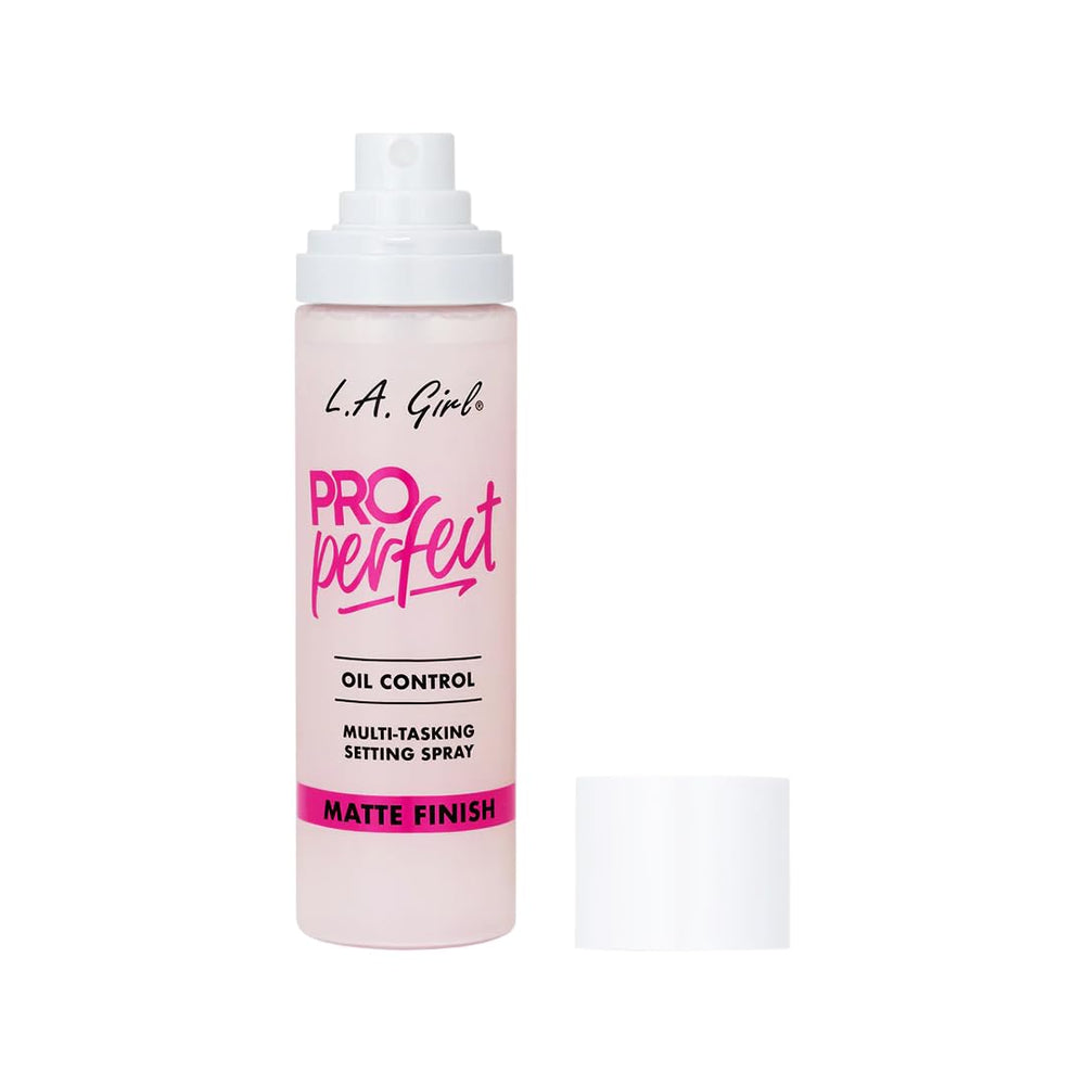 L.A. Girl bottle next to common items to show compact size and travel benefit