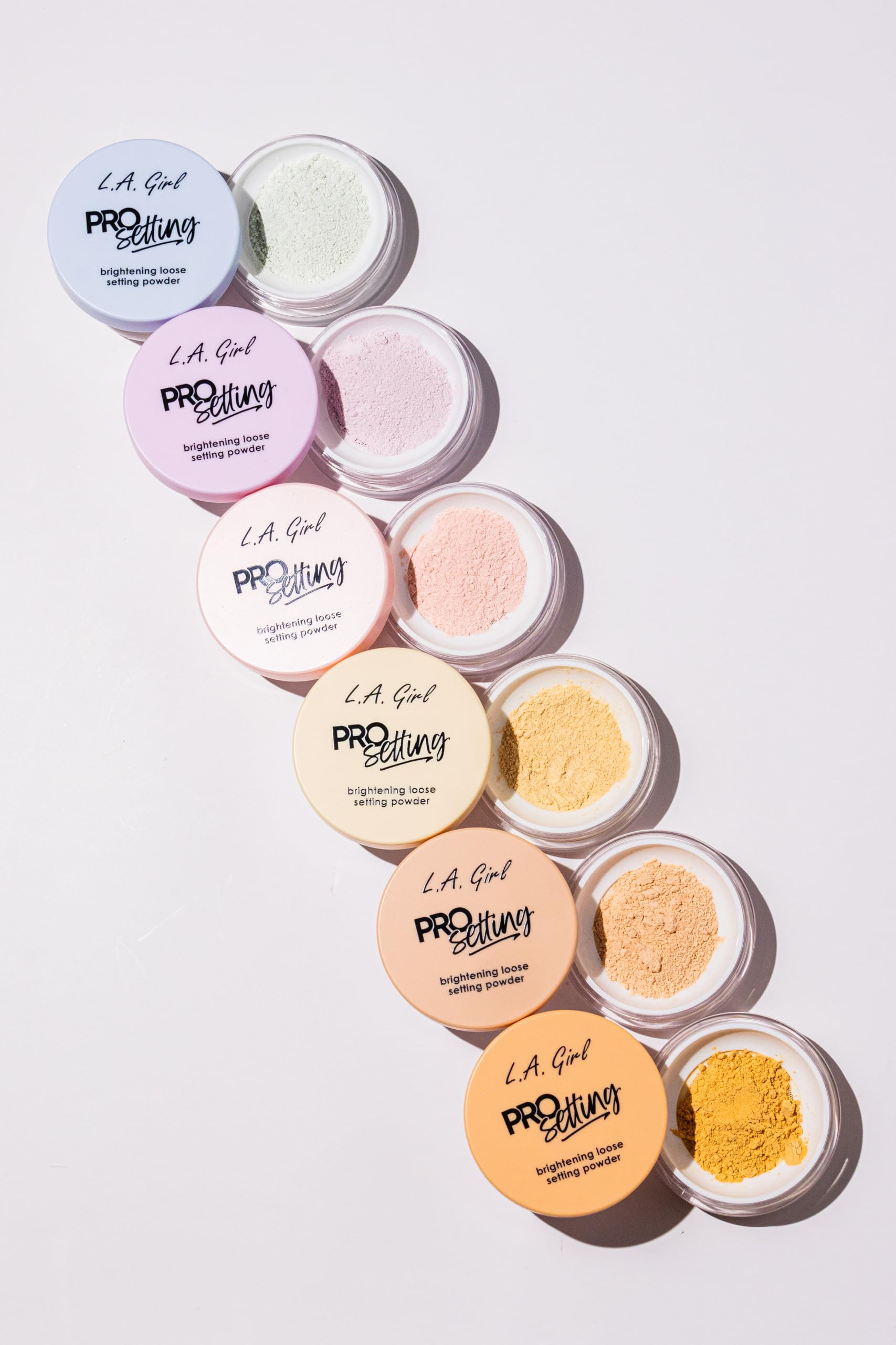 L.A. Girl powder with foundation swatches showing brightening and color-correcting benefit