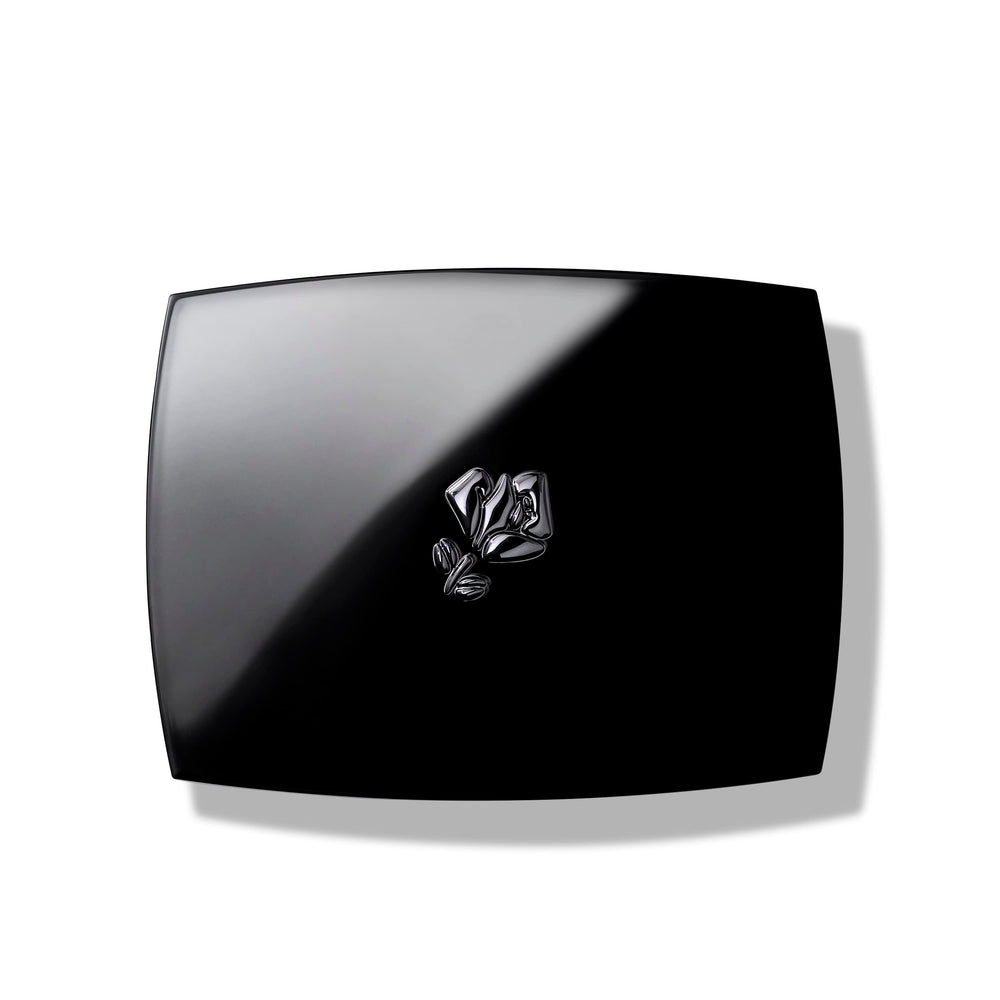 Lancôme blush in hand beside mirror showing scale and travel-friendly portability benefit