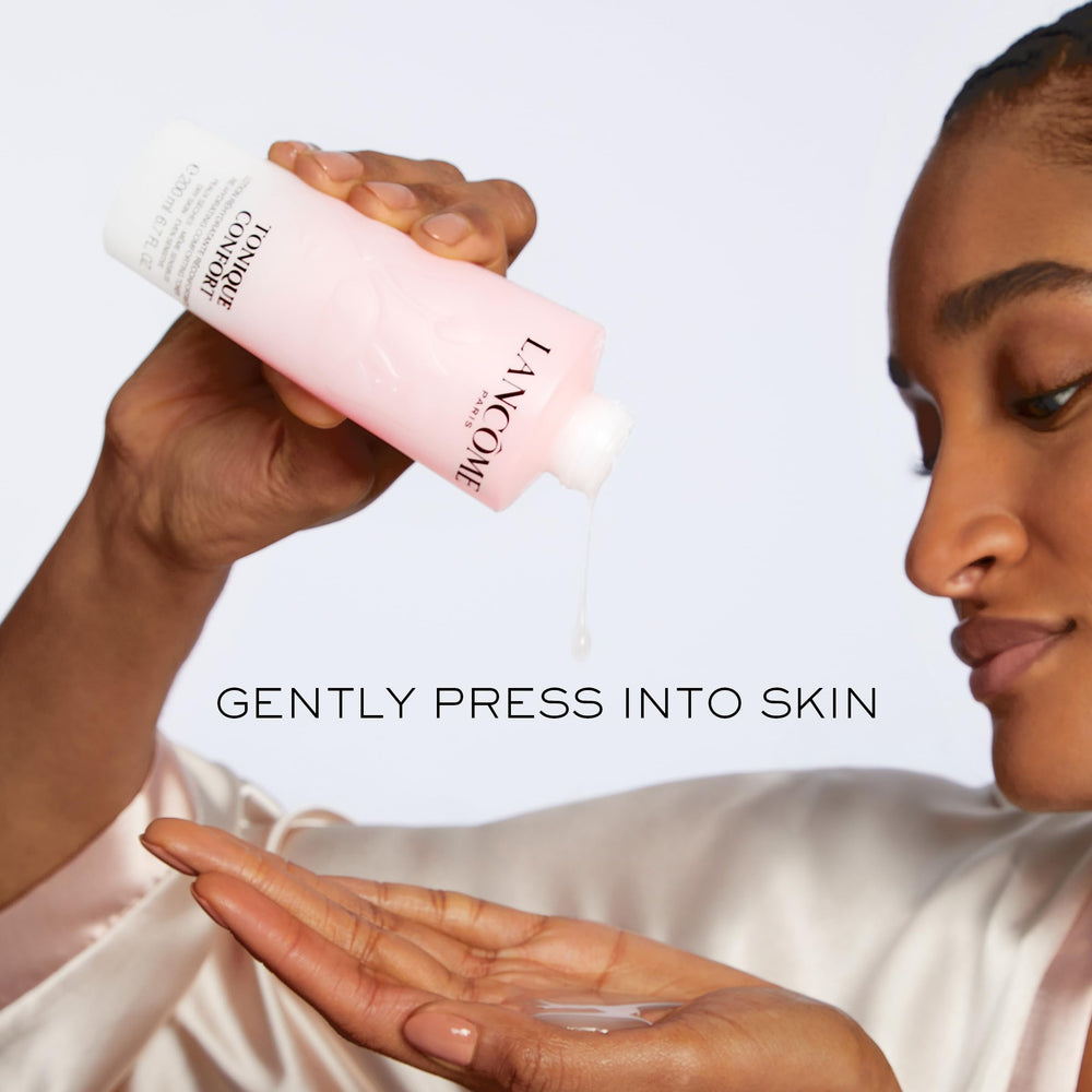 Lancôme bottle staged on vanity conveying daily routine convenience and radiance benefit