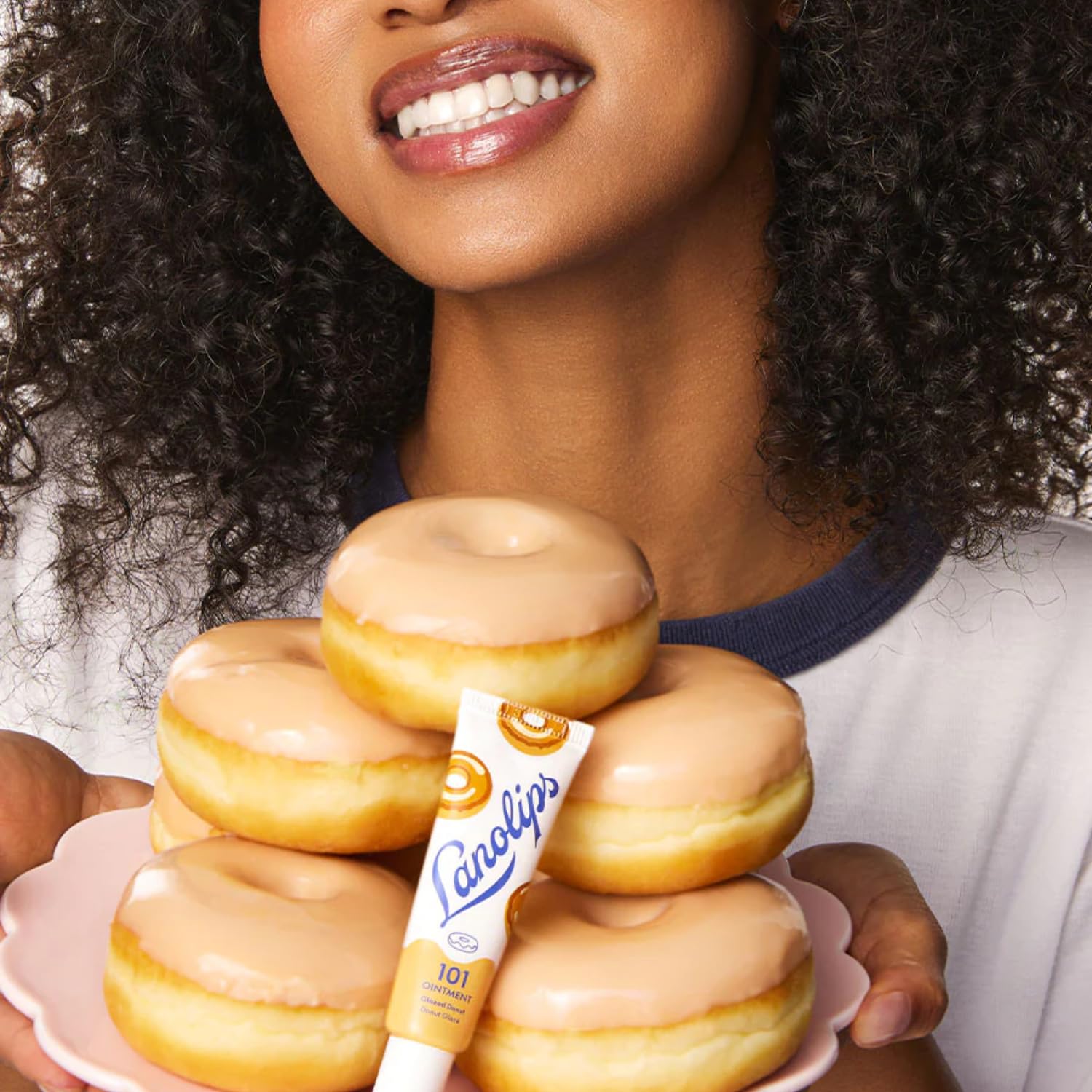 Lanolips glazed donut tin in a purse lifestyle shot conveying daily convenience