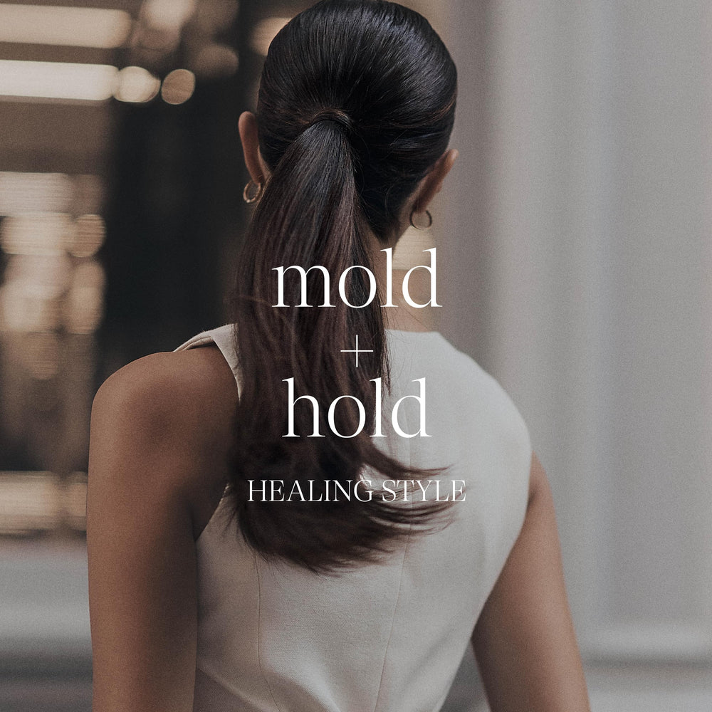 L’ANZA mirror lifestyle shot of person styling hair for polished, natural finish