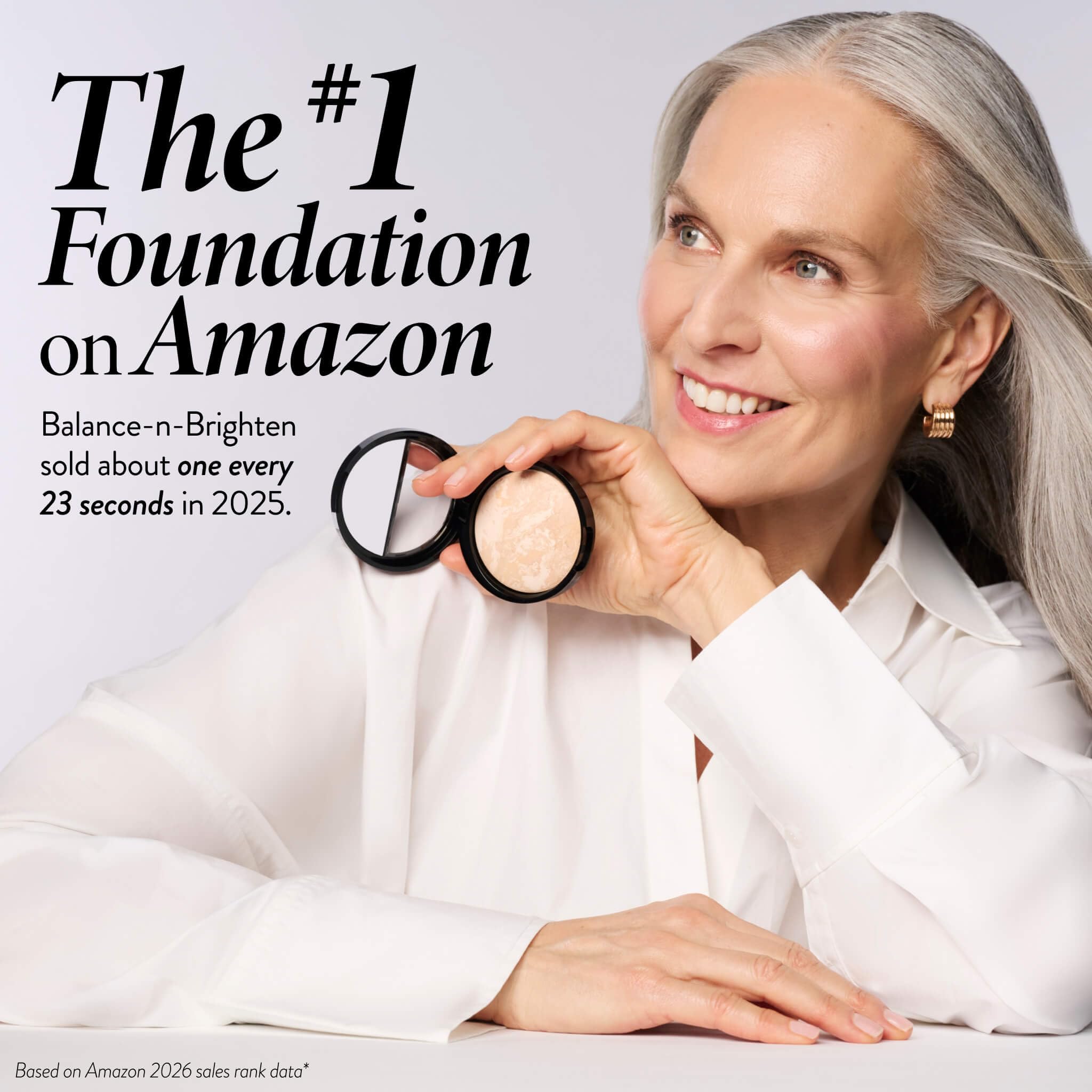 LAURA GELLER brush applying powder to model cheek for even coverage