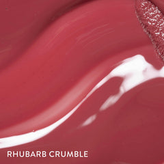 LAURA GELLER NEW YORK lip swatch in natural light showing buildable rosy-berry color and shine
