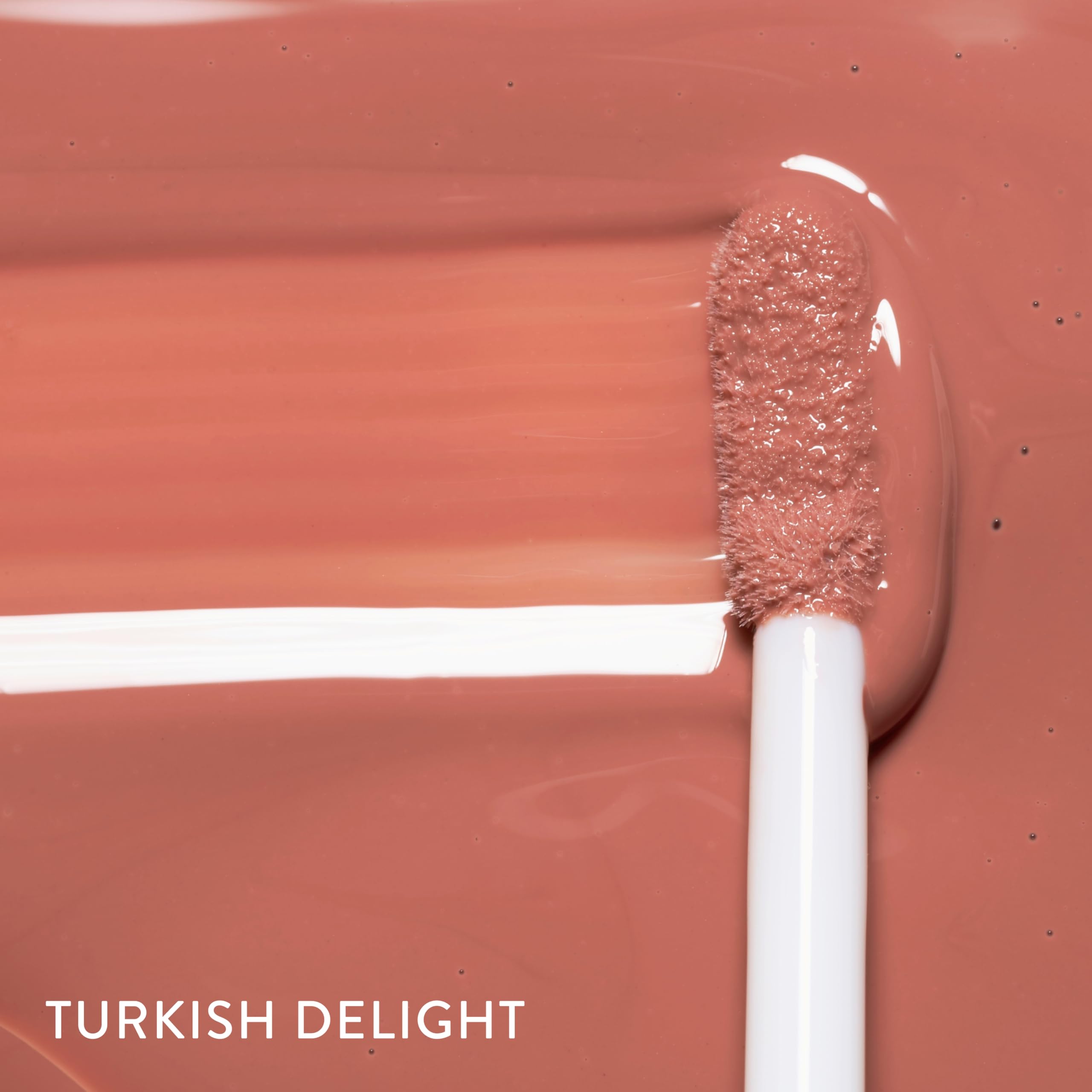 LAURA GELLER gloss on lips lifestyle image highlights luminous, fuller look
