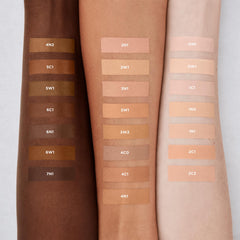Laura Mercier applicator wand applying concealer showing precise coverage control benefit