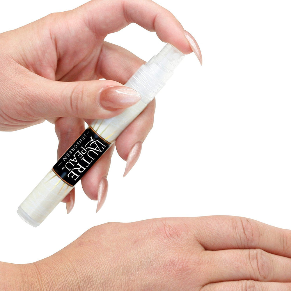 L'AUTRE PEAU applied on arm at beach showing water-resistant protection