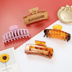 Hand holding LAXIZAR clips to show scale and portability for everyday use