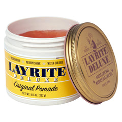 Layrite pomade close-up texture on fingertip, smooth paste for easy application