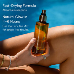 Lazy Tan bottle in hand for size comparison showing travel-friendly, compact design
