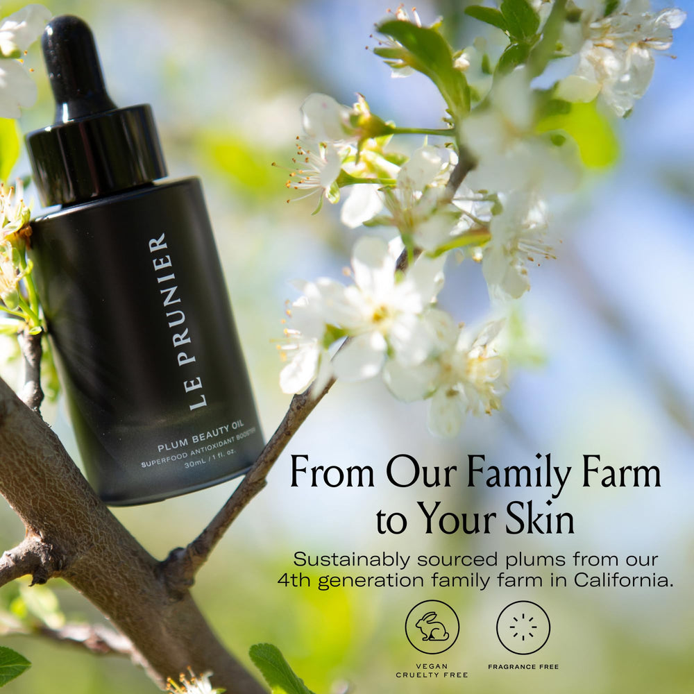 Hand applying Le Prunier oil to elbow to demonstrate moisturized skin benefit