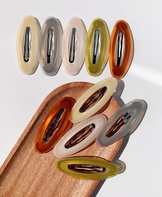 Lemeilleur front view of ten oval hair clips showing colors and packaging, durable hold