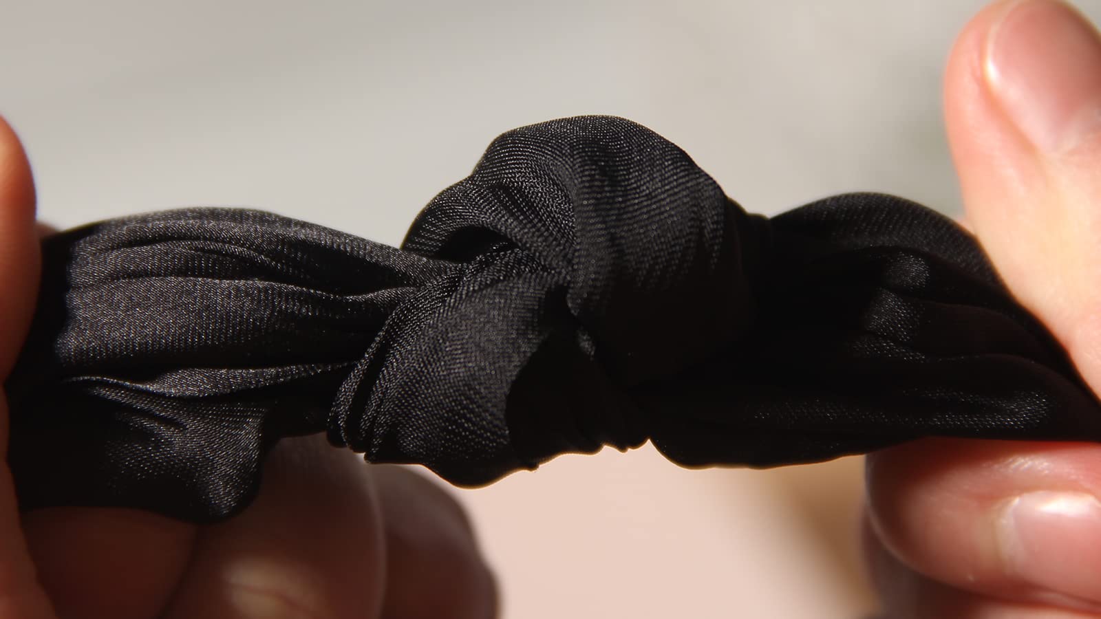 LFOUVRE scrunchie worn as wrist accessory demonstrating dual-use styling