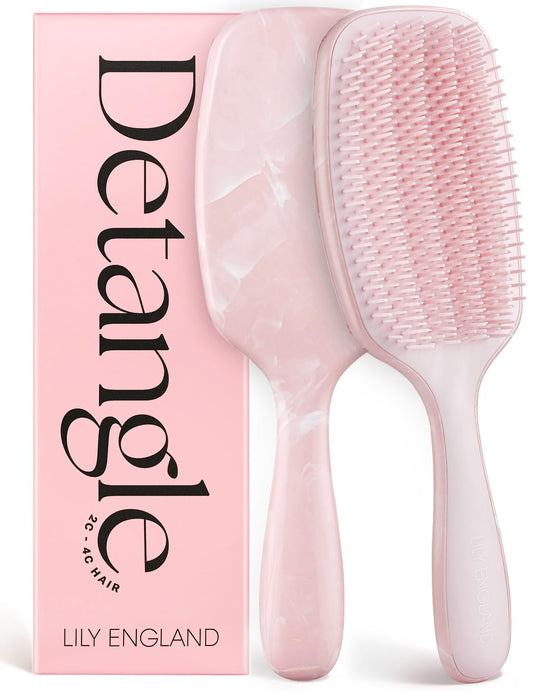 Lily England front view of pink detangling brush showing compact shape and ergonomic benefit
