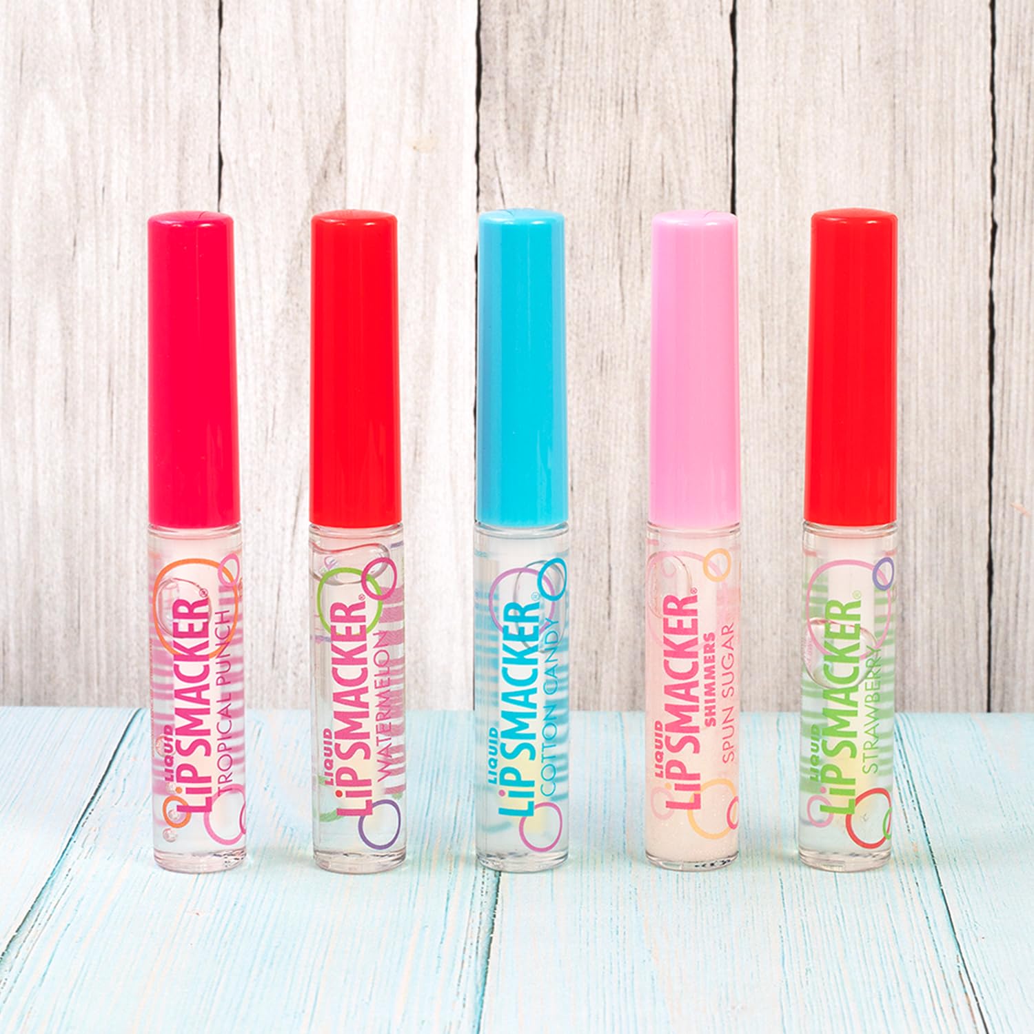 Lip Smacker pack beside a hand showing compact travel-ready size benefit