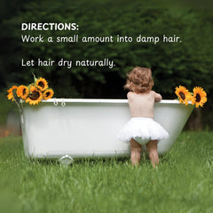 Little Green child applying cream to damp hair for defined curls benefit