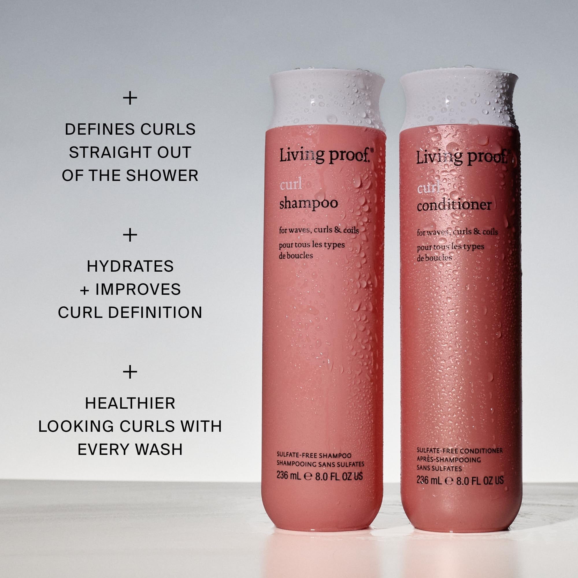Living Proof shampoo in shower on wet curls, displays cleansing and definition