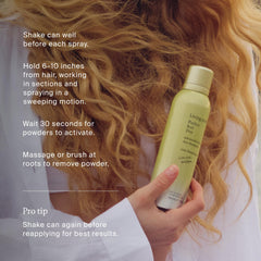 Living Proof bottle styled in beach summer setting conveying fresh fragrance benefit