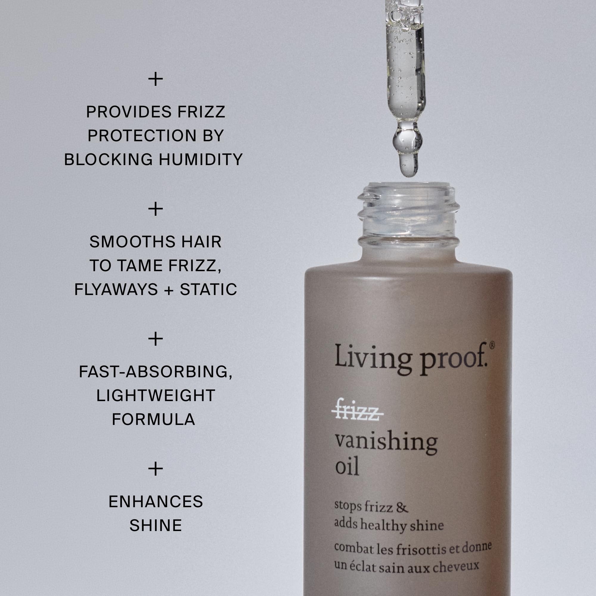 Living Proof oil being smoothed through mid-lengths showing frizz reduction benefit