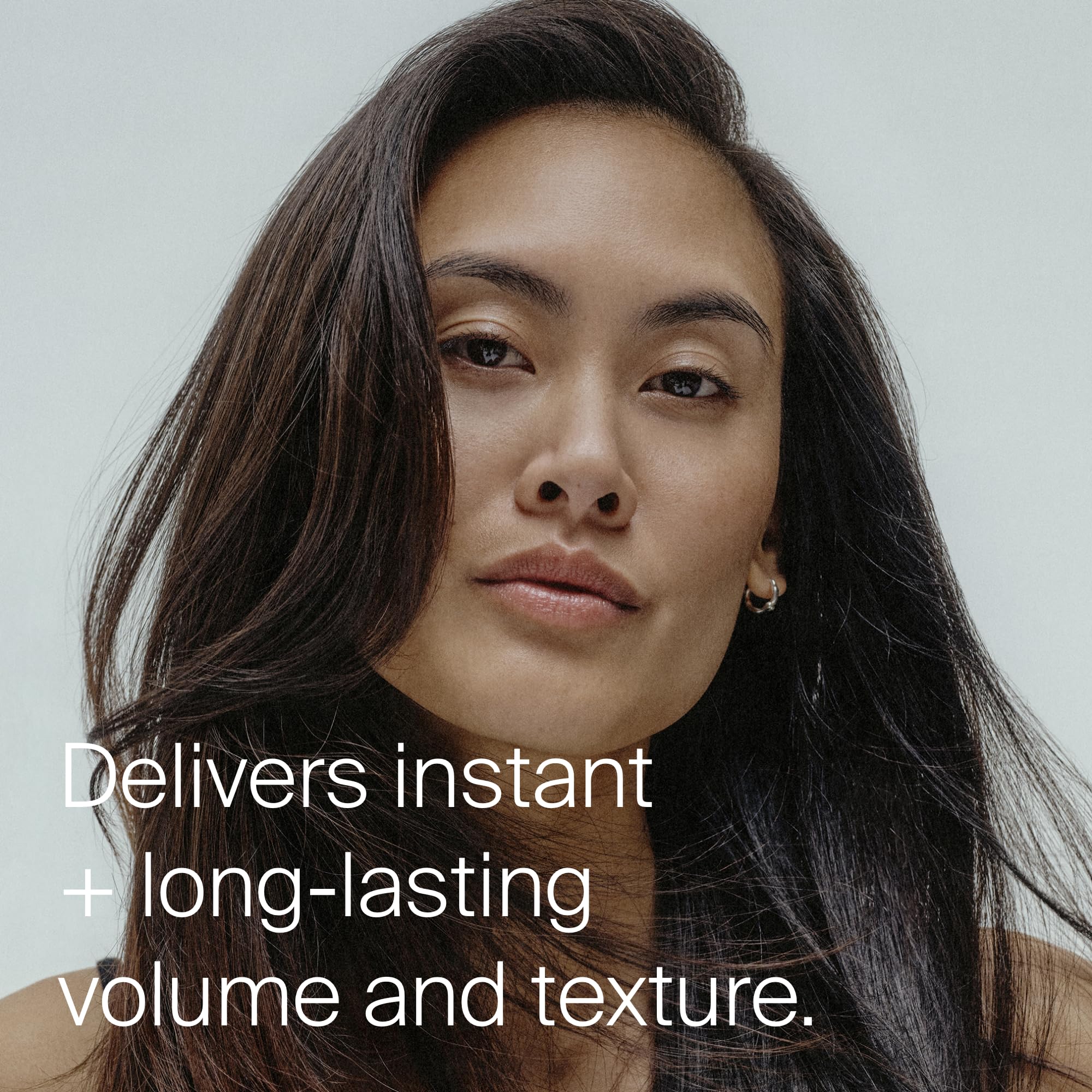 Living Proof fingers running through hair after texture spray showing improved movement
