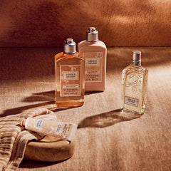 L'OCCITANE bottle beside bathtub and towel depicting a refreshing shower routine