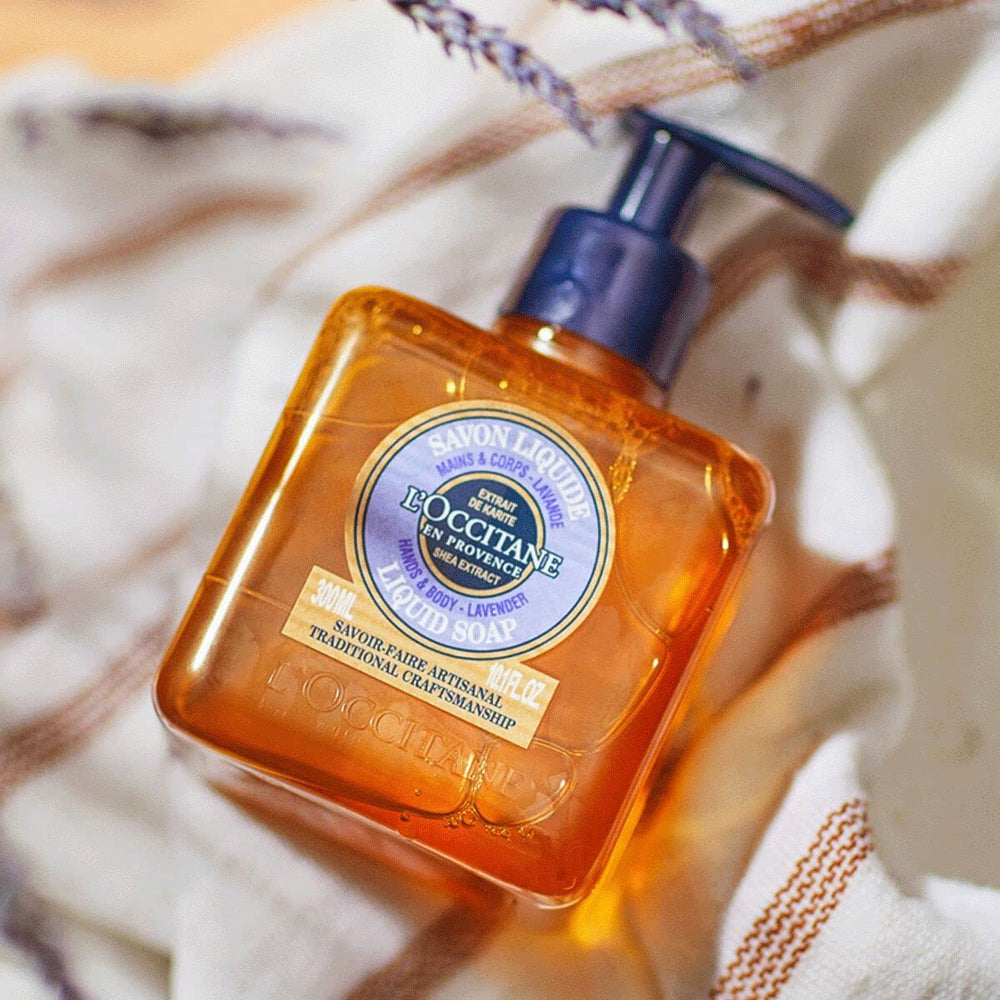 L'Occitane bottle in hand for scale showing travel-friendly 10.10 fl. oz benefit
