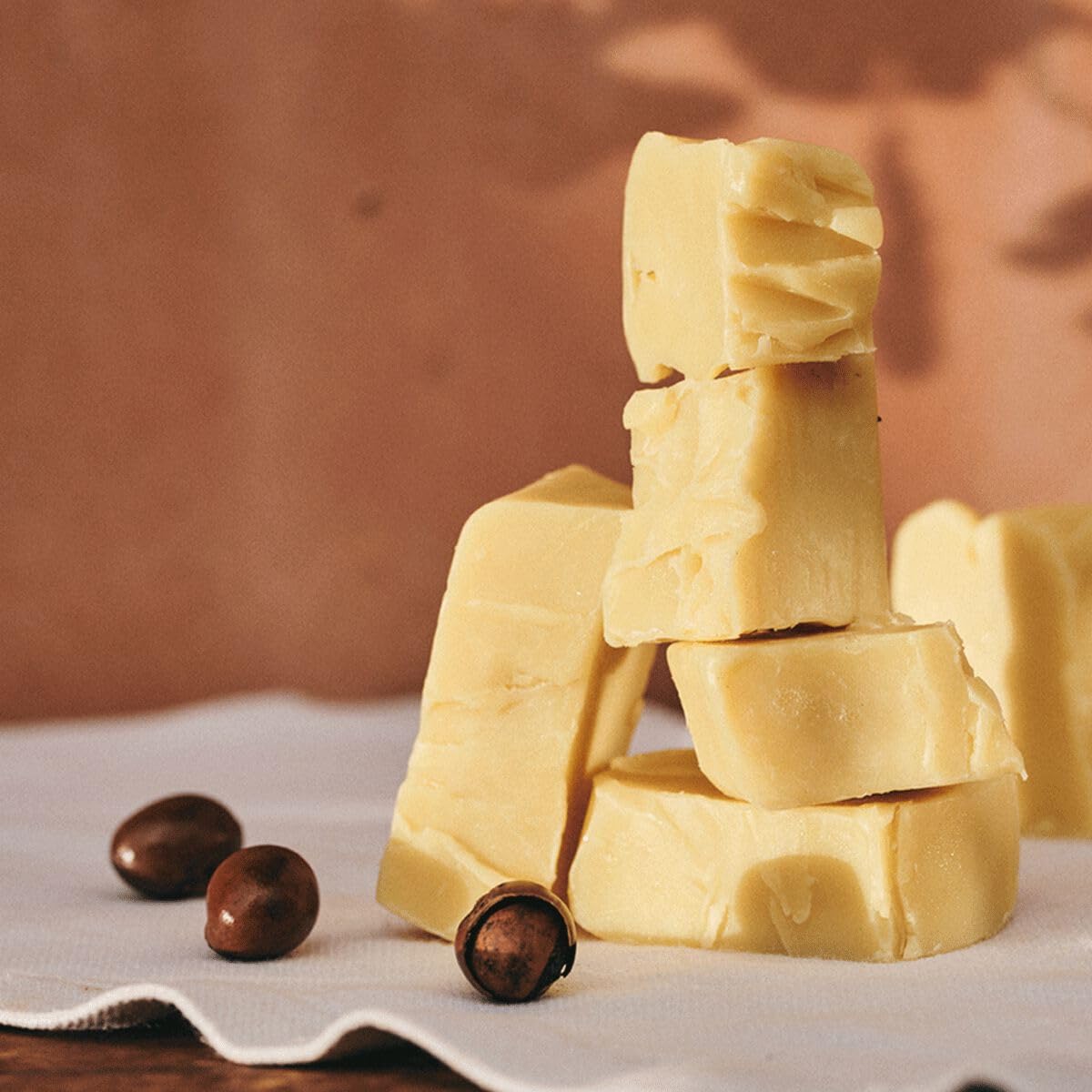 L'OCCITANE squeeze-tube open while applying to lips for precise, hygienic application