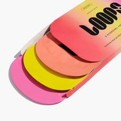 LOOPS mask sachet held in hand to show compact travel-friendly size