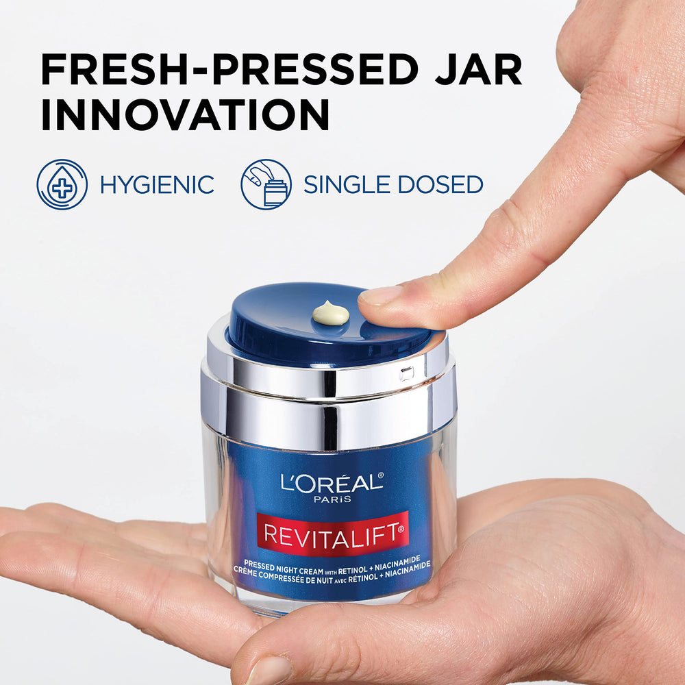 L'Oreal Paris 1.7 oz jar held to show scale and travel-friendly size