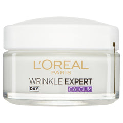 L'Oreal Paris cream in hand for size comparison and quick absorption benefit