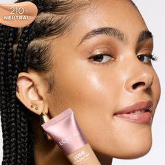 L'Oreal Paris bottle beside a coin showing size and travel-friendly benefit