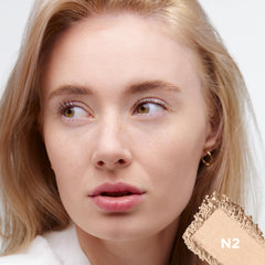 L'Oreal Paris True Match applicator next to powder demonstrating soft texture benefit