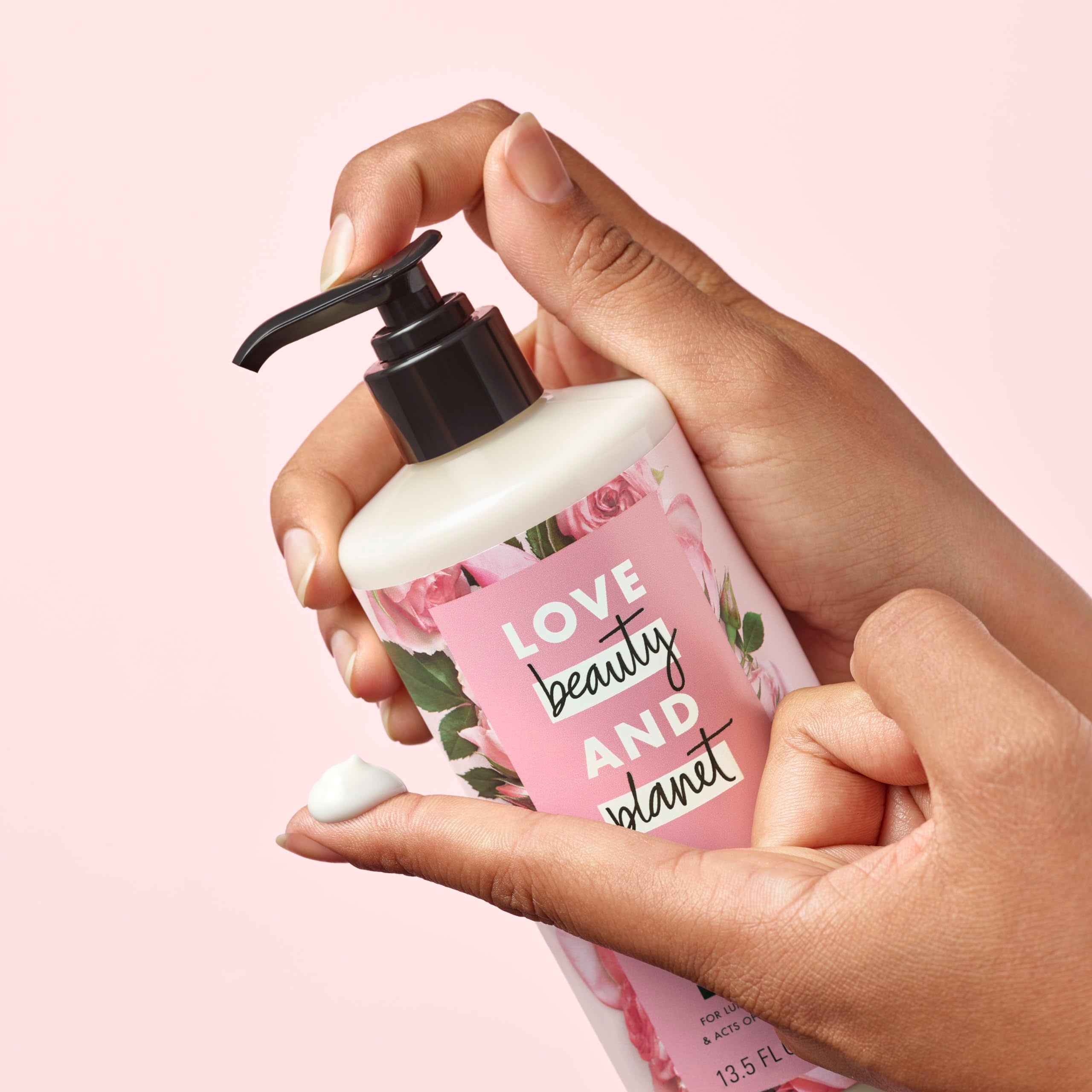 Love Beauty And Planet bottle held in hand illustrating 13.5 oz scale and ease-of-use benefit