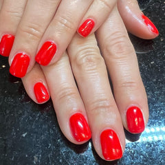 Love easy finished red manicure in lifestyle shot highlighting glossy results