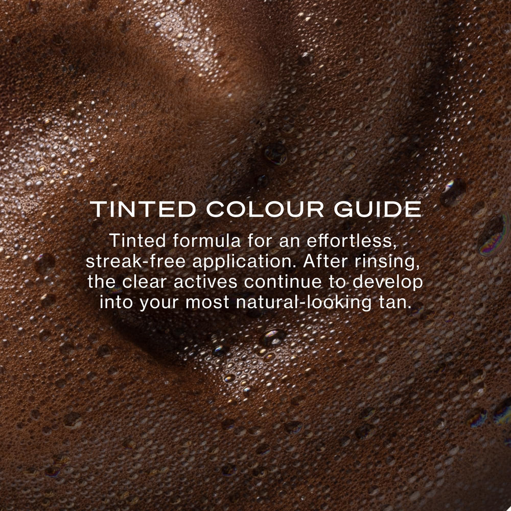 Loving Tan mousse on applicator mitt for streak-free blending